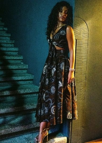 Model in a dark patterned dress at the Black Essence Fashion Show